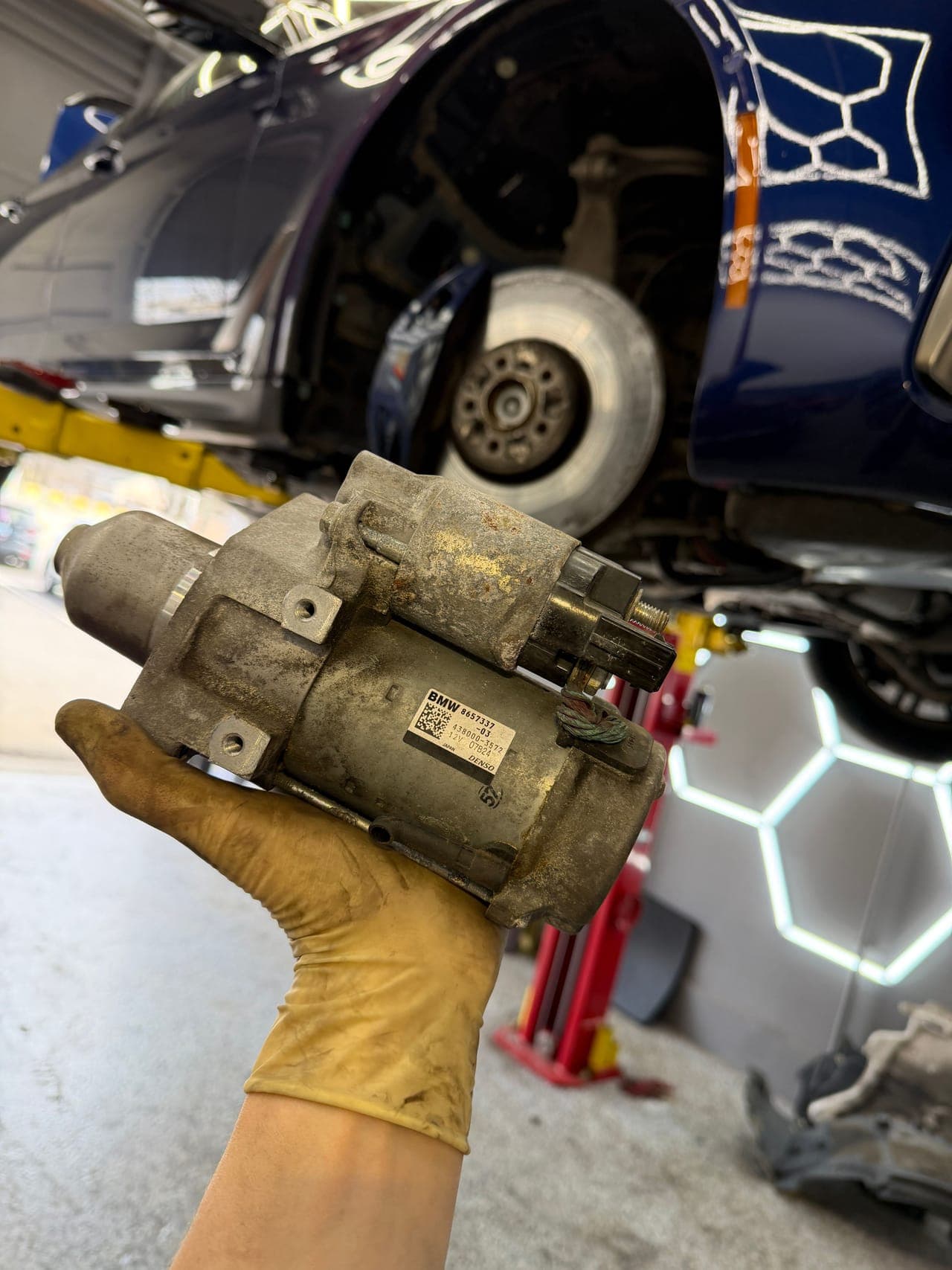 BMW starter replacement in progress.